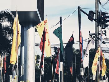 Panoramic shot of flags hanging against sky in city