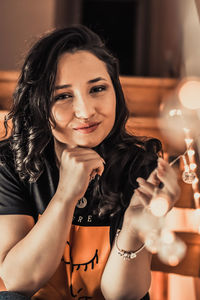 Portrait of young woman holding hands