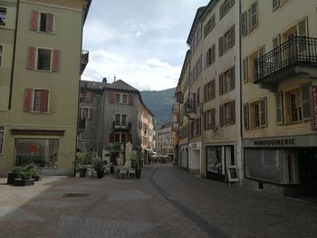 Street amidst buildings against sky