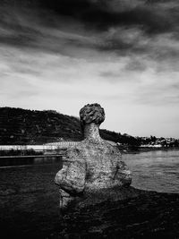 View of statue on beach against sky