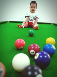 Boy playing with ball in pool