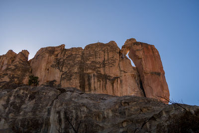 Low angle view of rock formation against clear sky