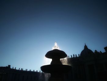 Low angle view of silhouette building against sky