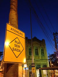 Low angle view of illuminated street light against sky