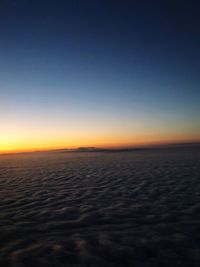Scenic view of sea against clear sky at sunset