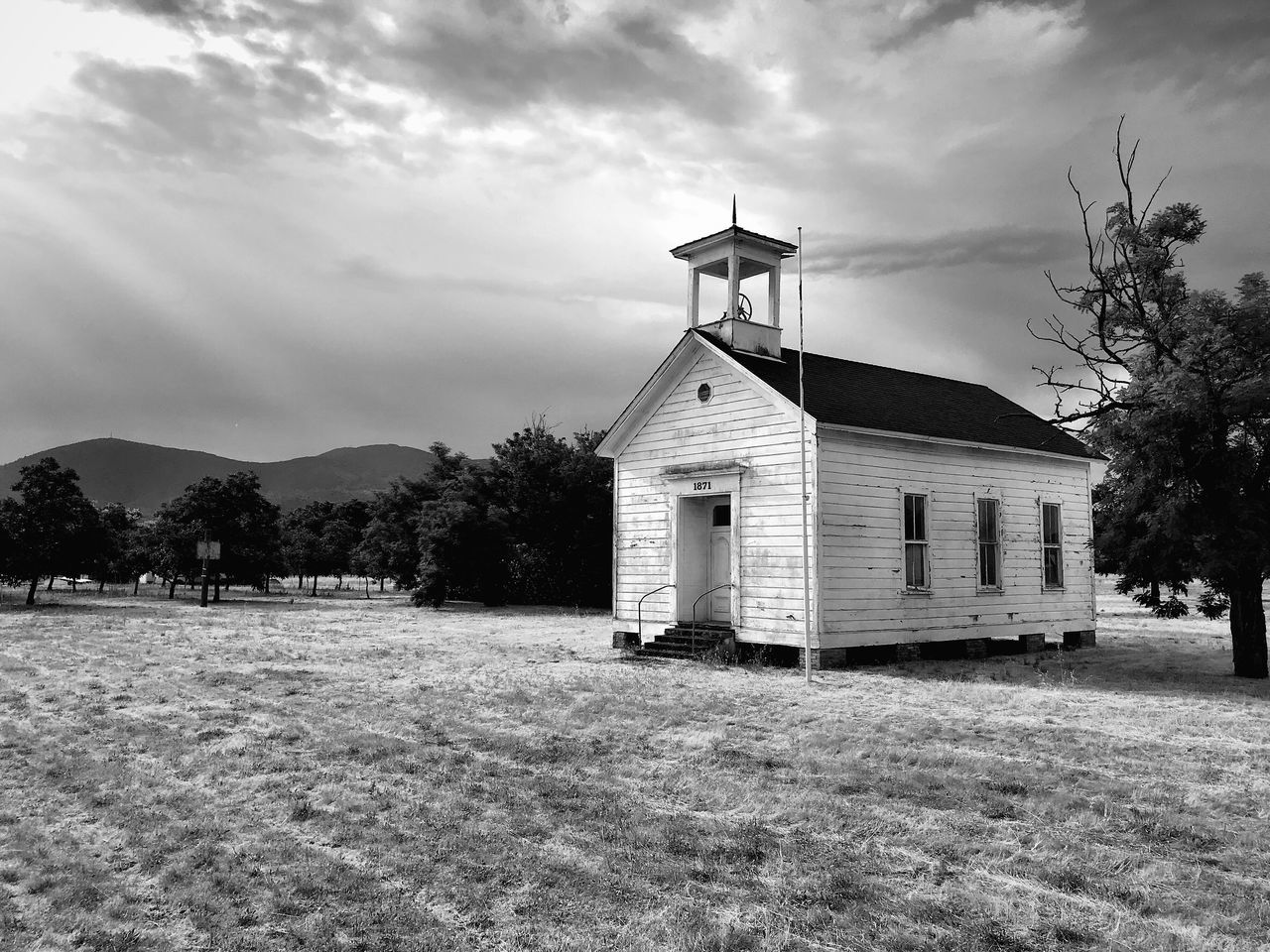 built structure, architecture, building exterior, cloud - sky, building, sky, tree, field, plant, land, nature, no people, grass, house, landscape, day, religion, place of worship, belief, outdoors