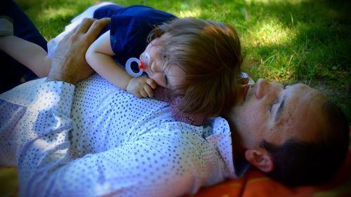 Man with daughter relaxing at park