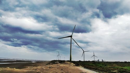 Windmill on field against sky