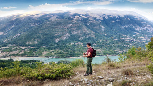 Full length of man standing on mountain against sky