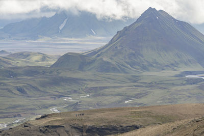 Scenic view of mountains against cloudy sky