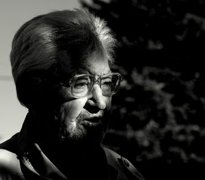 Close-up of senior man looking away while standing outdoors