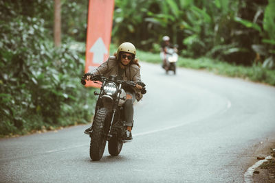 Man riding motorcycle on road