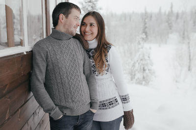 Young hipster couple hugs each other in a winter park. winter holidays.