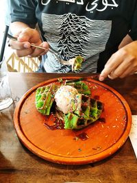 Midsection of man preparing food on table