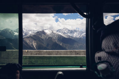 Scenic view of snowcapped mountains seen through window