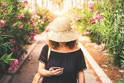 Midsection of woman using mobile phone outdoors