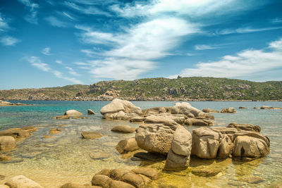 Rocks on beach against sky