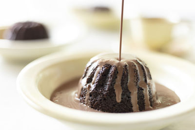 Hot chocolate poured on chocolate cake