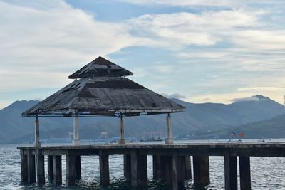 Pier over lake against sky