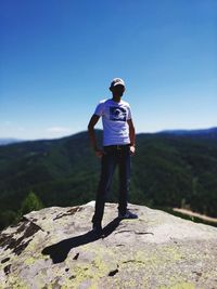 Rear view of man standing on mountain