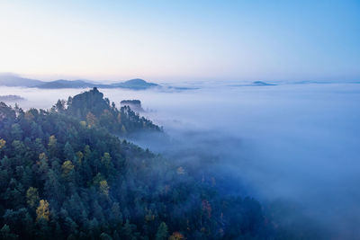 Mountain islands and misty valley, mountain peak with cabin at sunrise. beautiful autumn panorama