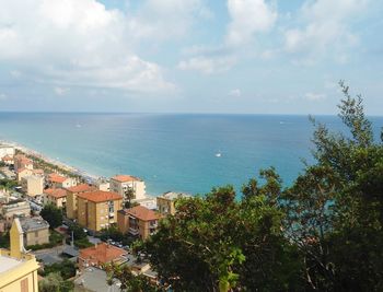 High angle view of townscape by sea against sky
