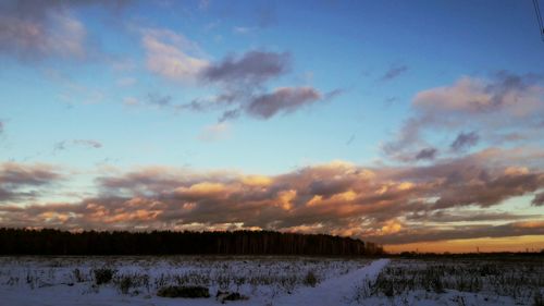 Scenic view of landscape against sky during winter