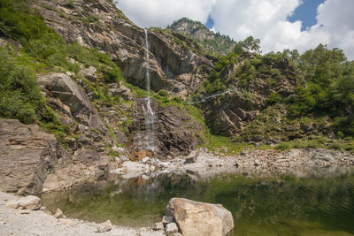 Panoramic view of antrona lake and sajont waterfall in piemonte