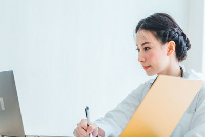 Portrait of young woman using mobile phone