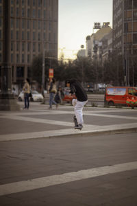 Rear view of woman walking on street in city