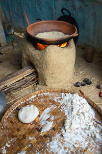 Rice floor bread making in traditional soil vessels at wood fire from different angle