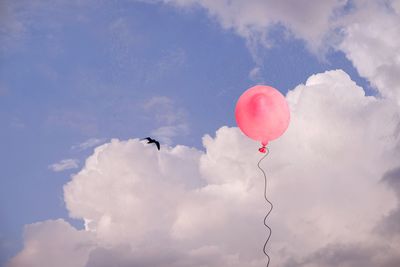 Low angle view of balloons against sky