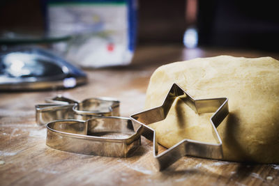 Christmas baking. making gingerbread biscuits. cookie dough and cookie cutters on kitchen counter.
