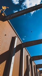 Low angle view of building against cloudy sky