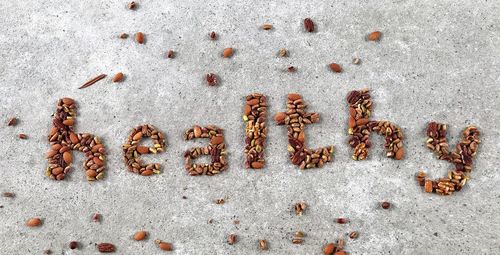 Directly above shot of healthy text made with nuts on table