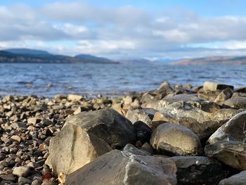 Rocks on beach against sky