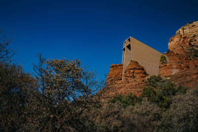 Low angle view of building against clear blue sky