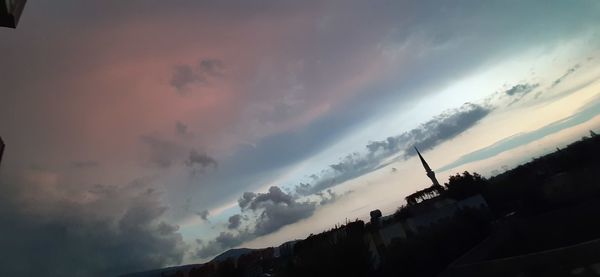 Low angle view of silhouette buildings against sky during sunset