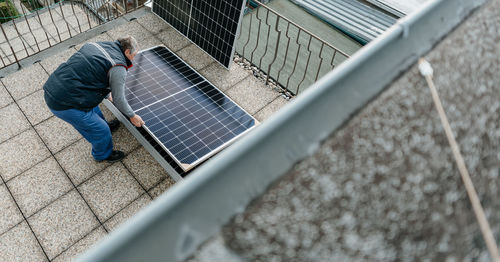 High angle view of engineer inspecting solar panel