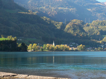 Scenic view of lake by trees against mountain