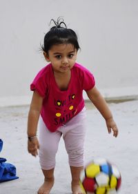 Cute girl playing with toy at beach