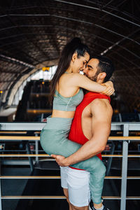 Portrait of young couple in love having a special moment in gym clothes