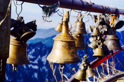 Close-up of metallic bell tied on poll