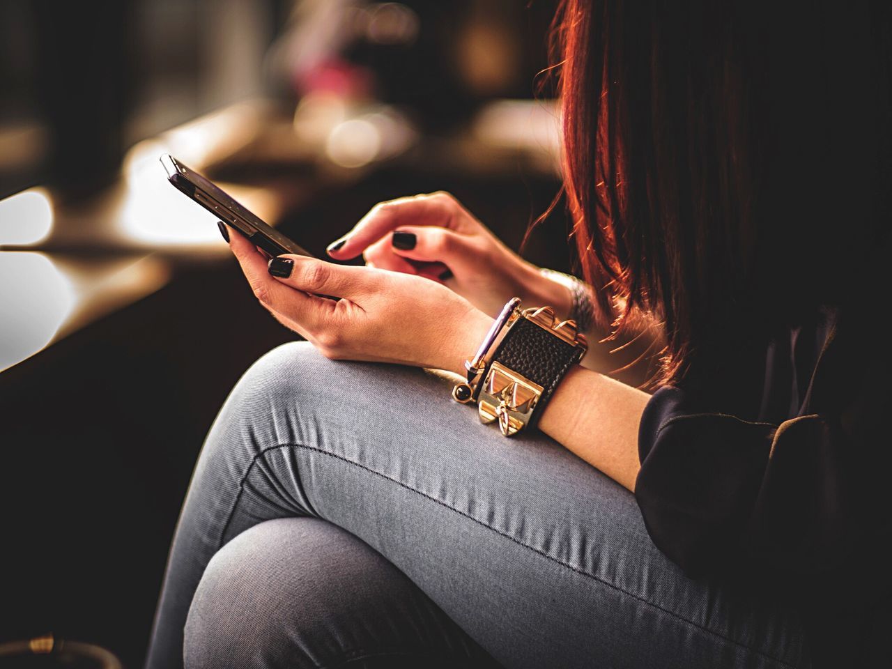 lifestyles, person, indoors, leisure activity, sitting, focus on foreground, young women, relaxation, part of, young adult, midsection, close-up, holding, casual clothing, side view, sensuality