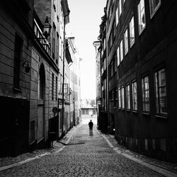 Rear view of woman walking on street in city