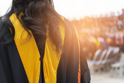 Woman wearing mortarboard against sky