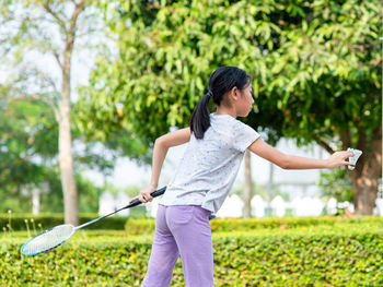 Full length of woman playing on grass