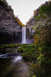 Scenic view of waterfall against sky