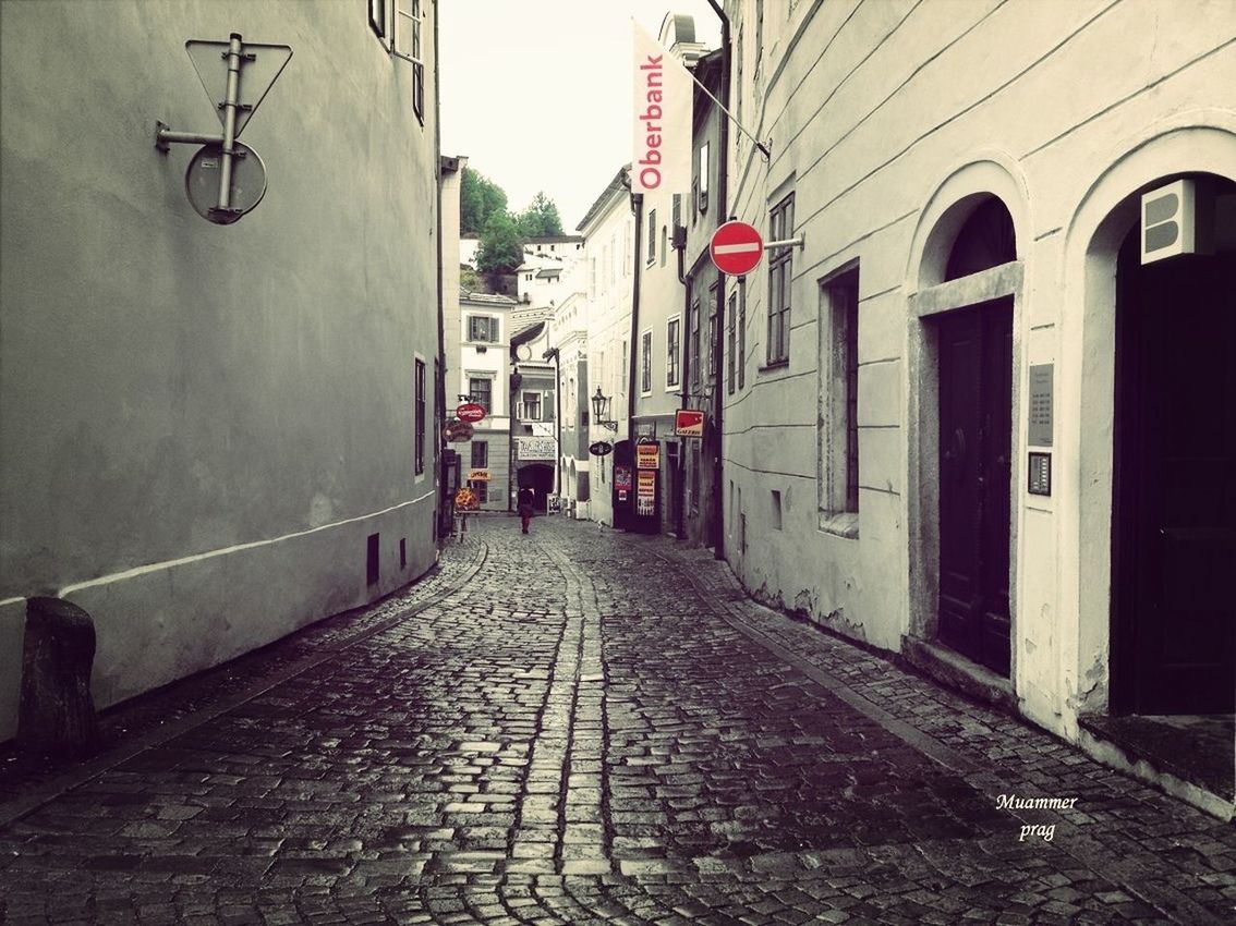 architecture, built structure, building exterior, the way forward, diminishing perspective, narrow, street, building, empty, alley, cobblestone, vanishing point, long, transportation, walkway, day, city, residential building, residential structure, no people