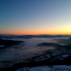 Scenic view of snowy landscape against sky during sunset